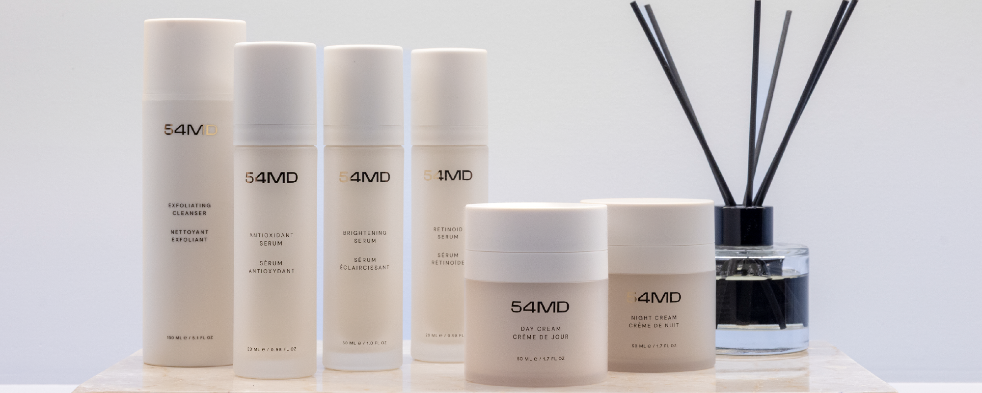 Set of 54MD skincare products on a light background